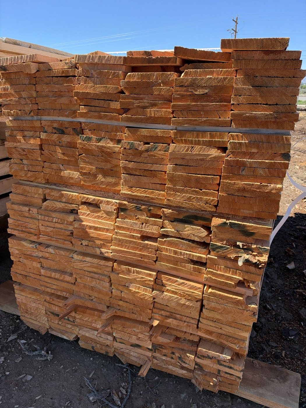 Stack of rough circle sawn Doug fir 1x8 boards in the JAMCo yard