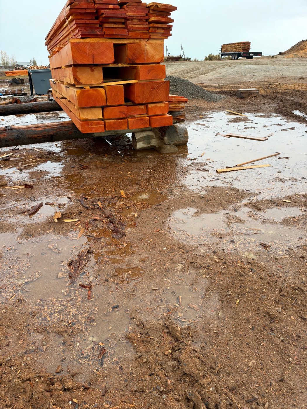Standing water and mud in the JAMCo log yard, October 2026