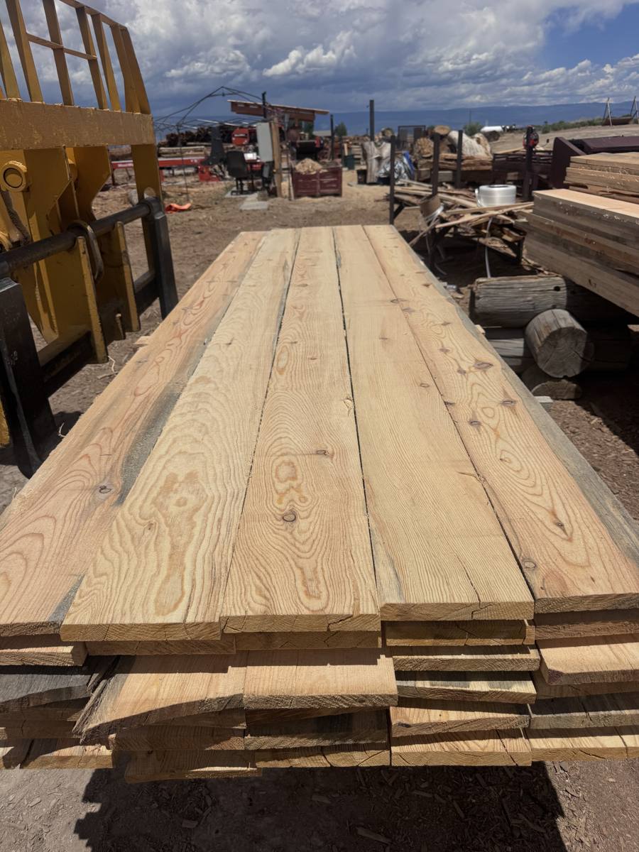 Fresh rough sawn pine boards on a lumber stack at the JAMCo yard, some with blue stain