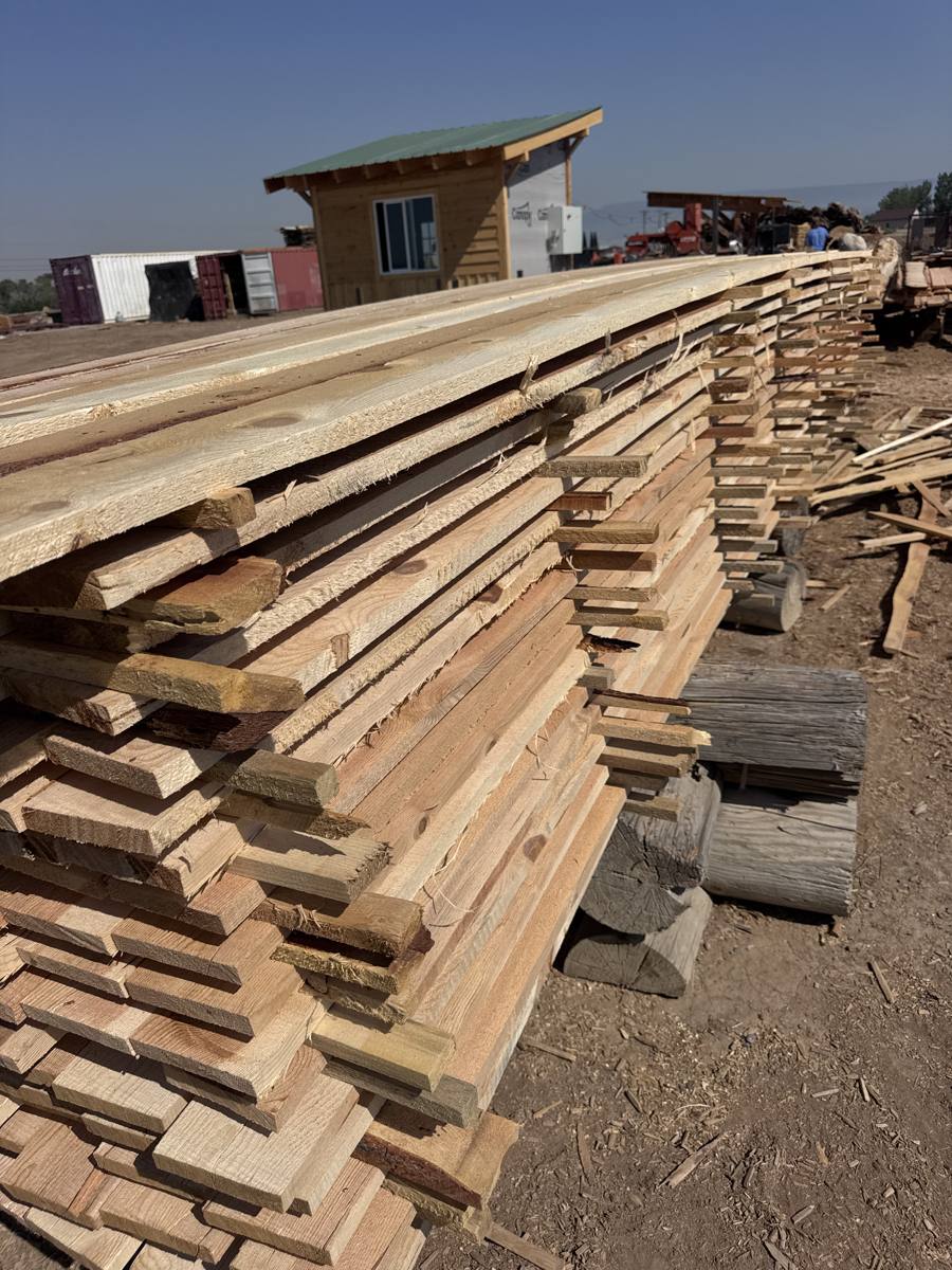 Long stack of rough sawn boards stacked and stickered in the JAMCo yard